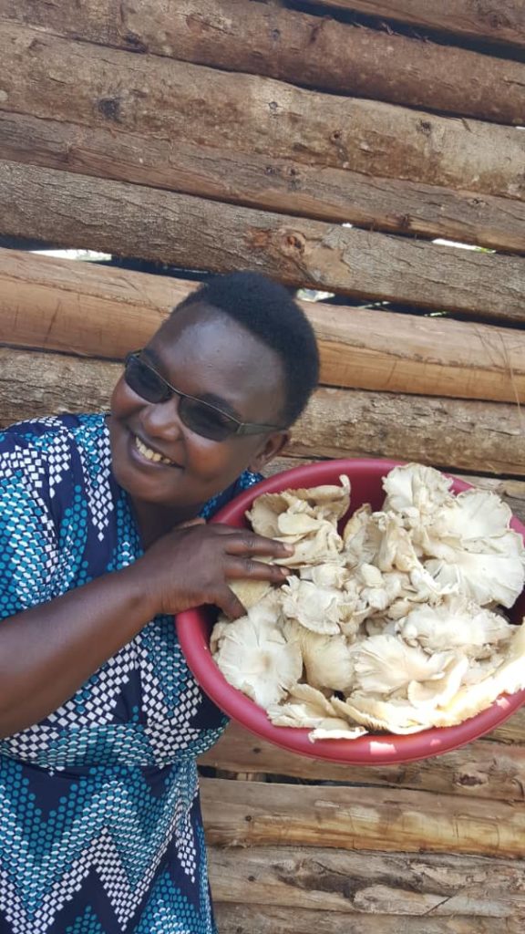 Founder Josephine holding a plate of mushrooms